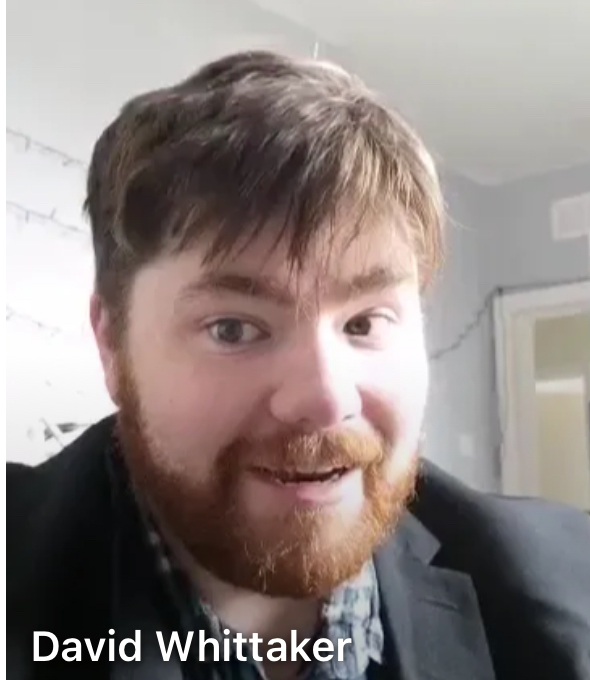 Young man with beard looking at camera