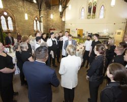 Team talk - we all need motivation and encouragement before the performance begins! The full team stands in the centre of the venue as Fiona Armstrong, Lord Leutenant and Joint COmpere gives a motivational speech. Everyone, chefs, trainees and mentors are engaged and listening.