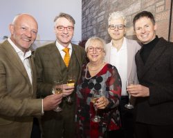 Johnny Lornie, Fraser McFadzean, Bundy Walker, Damian Jennison, Alex McQuiston Four men and one lady stand smiling at the camera. All are holding a glass of sparkling wine.
