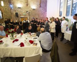 Congratulations to everyone who made this event happen today. While guests sit in the foreground at tables, in the background the comperes have invited all the chefs and servers to the main area of the hall to take the applause of the guests