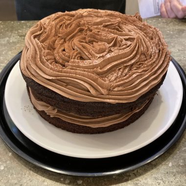 A chocolate cake that one of the volunteers made in the centre of the photo.